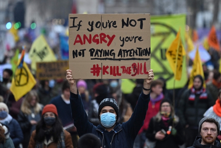 New policing bill threatens youth mental health and minority ethnic communities, say experts Demonstrators hold up placards as they take part in a march to protest against the Police, Crime, Sentencing and Courts Bill in London on January 15, 2022. - Marches are planned in several UK cities to support the Kill the Bill coalition. Protesters are calling on the House of Lords to reject the Police, Crime, Sentencing and Courts Bill. (Photo by JUSTIN TALLIS / AFP) (Photo by JUSTIN TALLIS/AFP via Getty Images)
