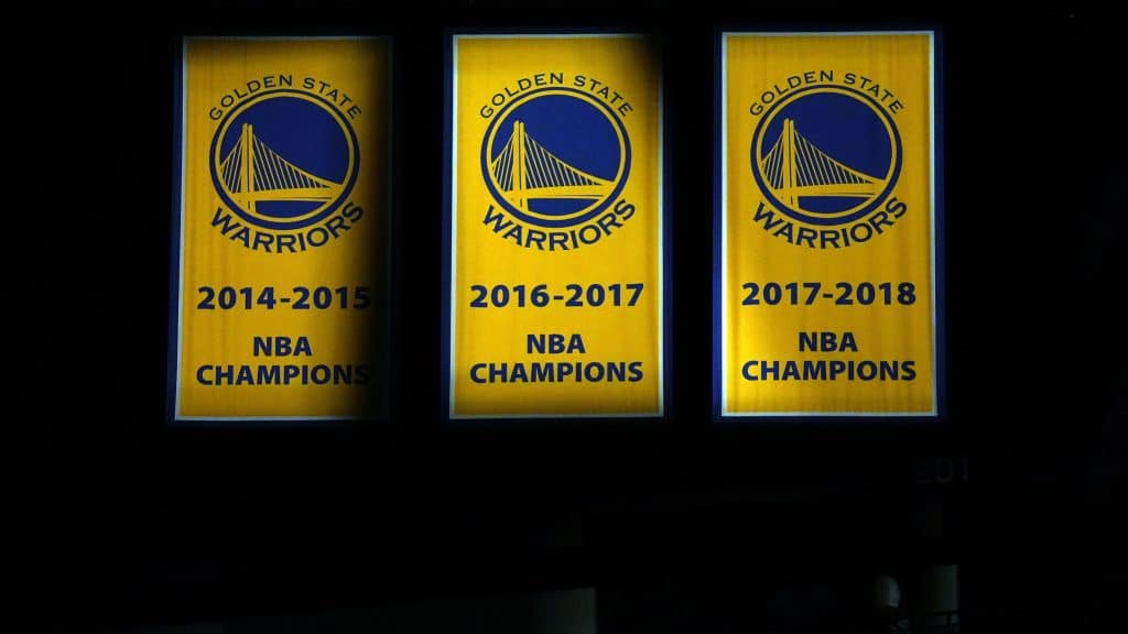 Warriors distance themselves from partial team owner after his comments about Uyghurs in China Golden State Warriors championship banners hang inside the arena on Nov. 26, 2021.