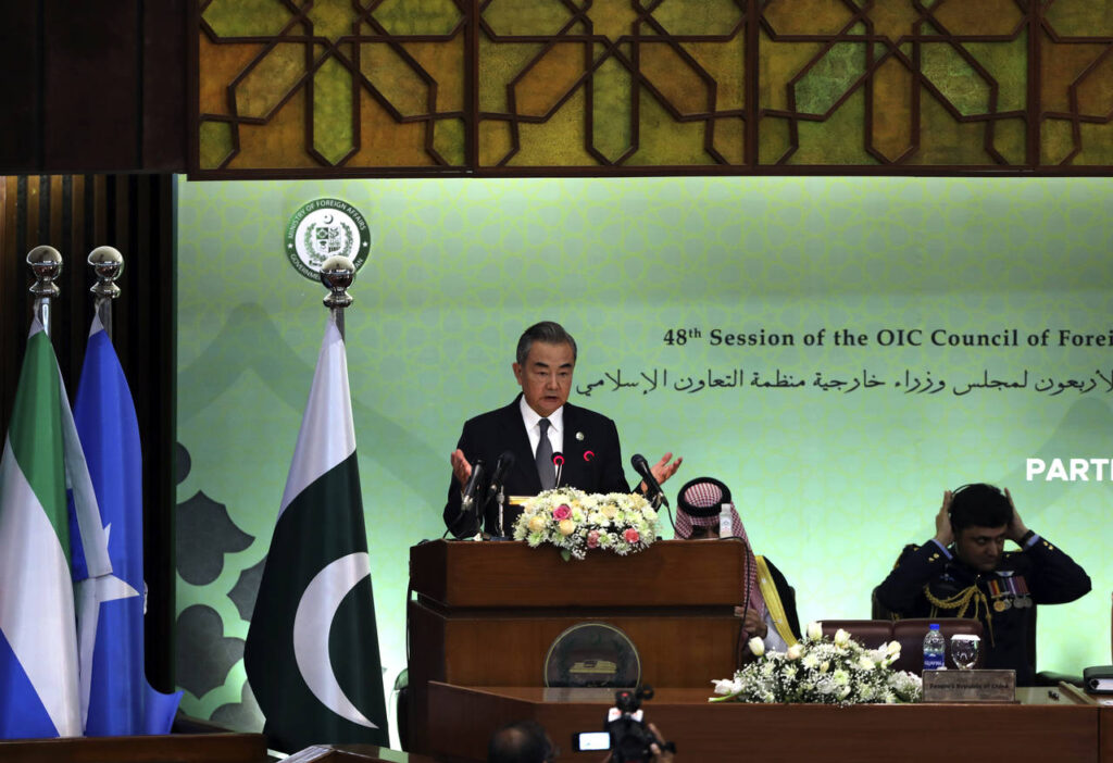 Chinese Foreign Minister Wang Yi speaks at the start of a two-day gathering of the 57-member Organi...